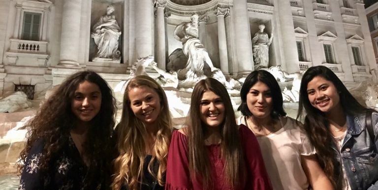 students standing in front of Trevi Fountain