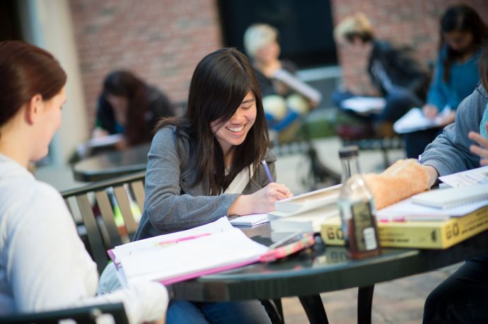 student writing outdoors