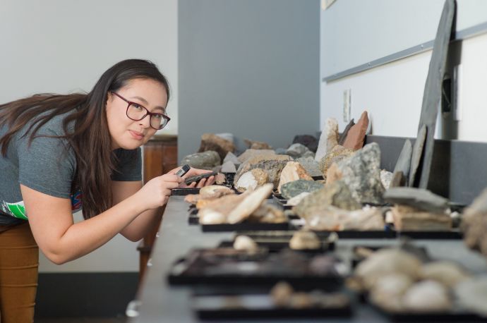 Student studying rocks in classroom