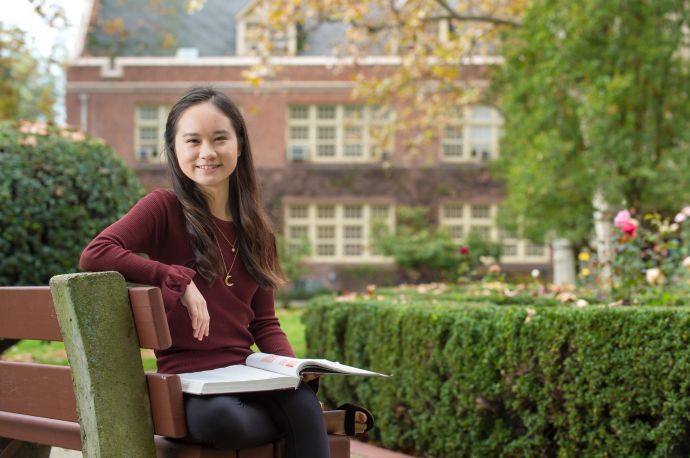 Language student sitting on bench