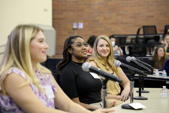 Students talking on a panel 
