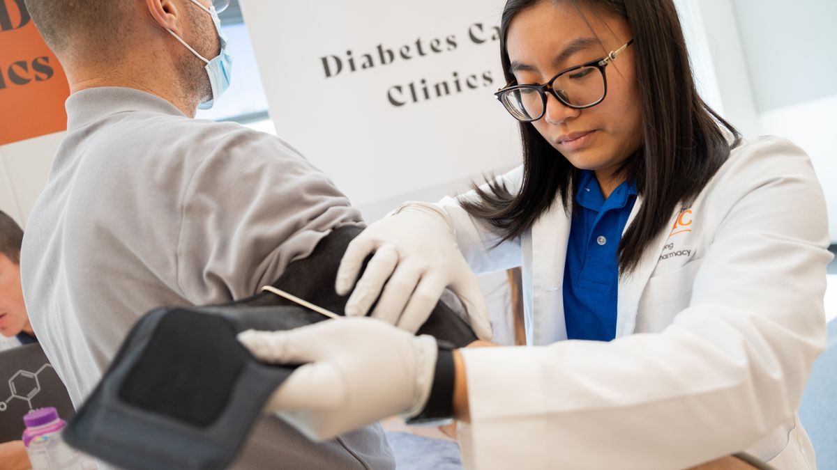 a student works with a patient at a diabetes care clinic