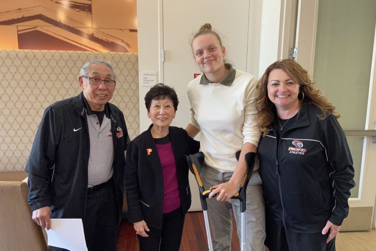 hiratas pose for a photo with a scholarship recipient and the engineering dean