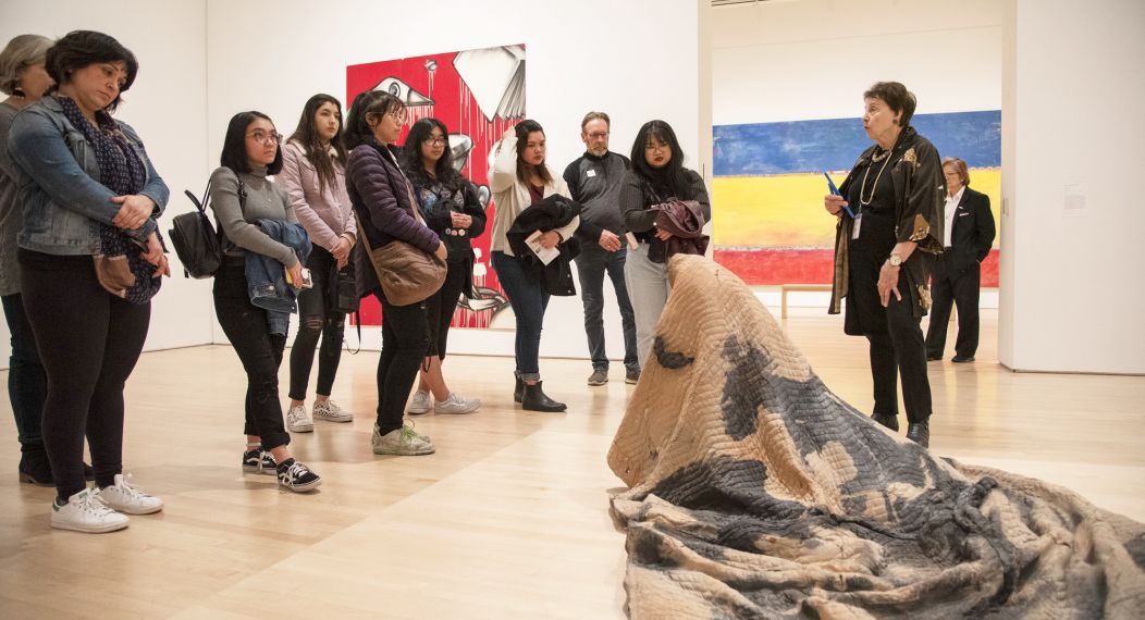 students look at artwork during a Humanities trip to SF MOMA