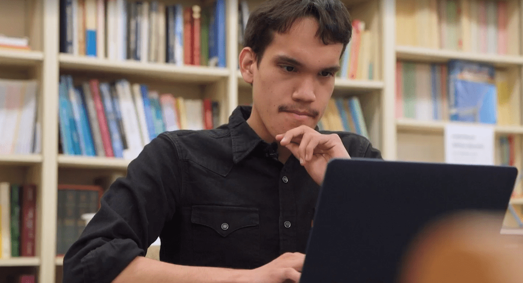 Oscar Avalos, math major, works on his laptop.