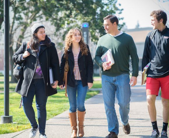 students walking around campus with professor Lenzi
