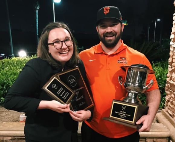 debate team members holding awards